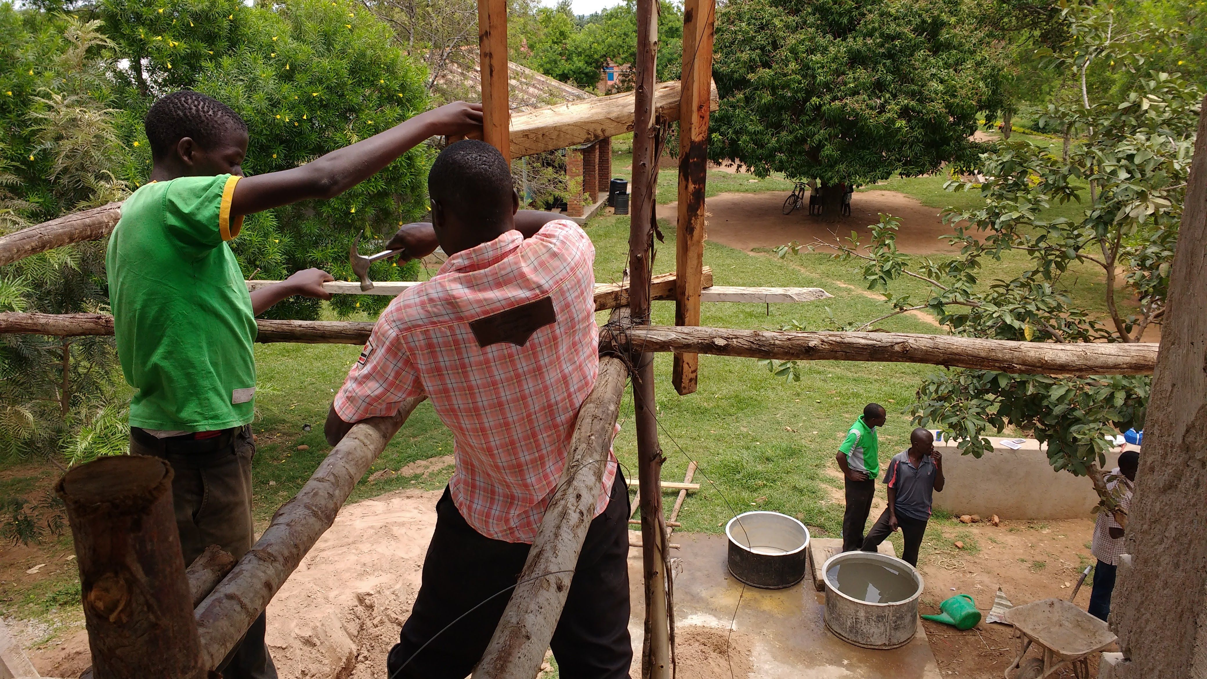 Scaffolding and ladder rigging for water tower access in Uganda